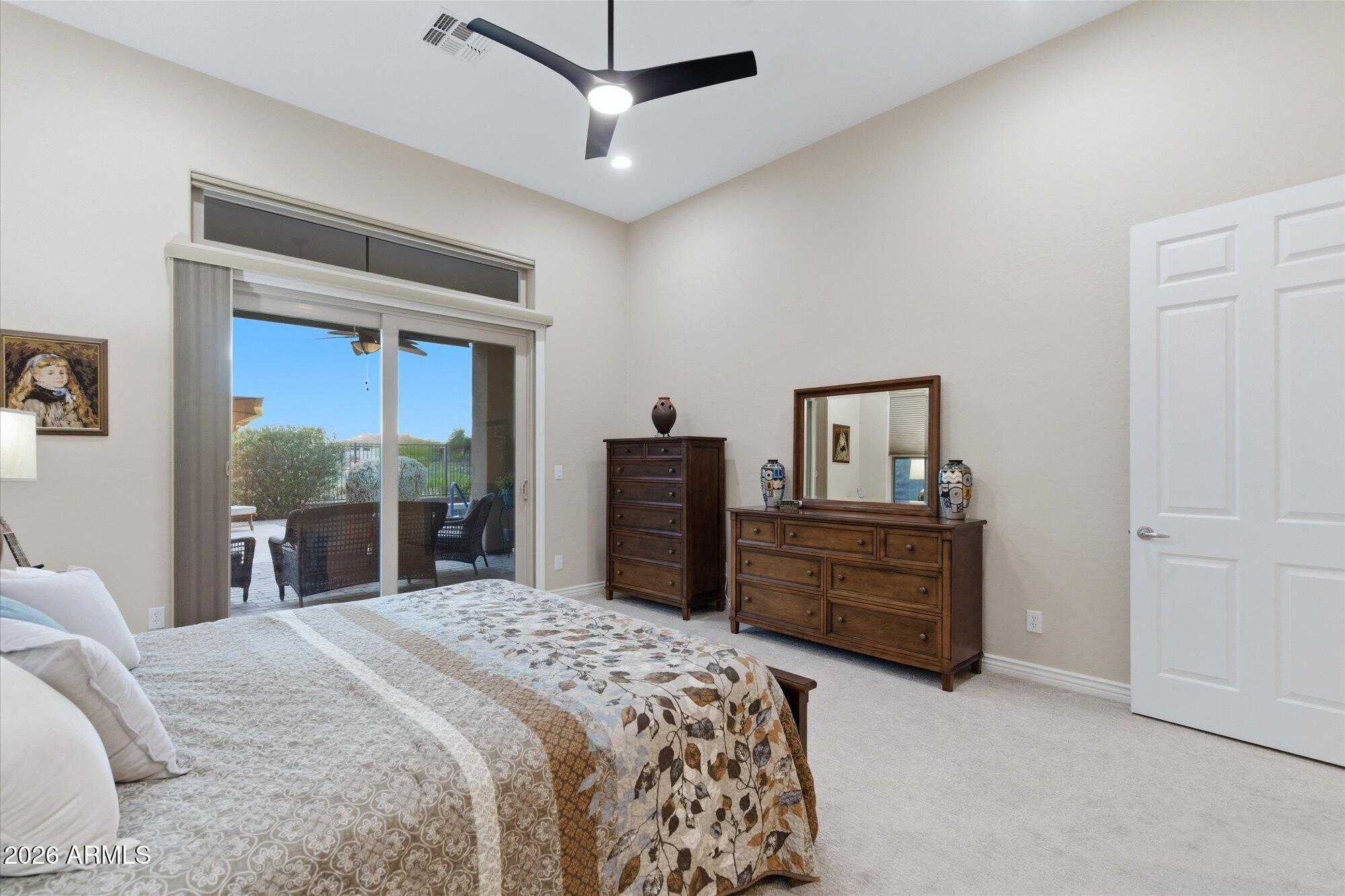 40322 North Hawk Ridge Trail Anthem, AZ 85086 - Photo 27 of 63 a bedroom with a bed dresser and a large window