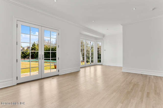 60 Club Road Riverside, CT 06878 - Photo 19 of 44 a view of an empty room with a window and wooden floor