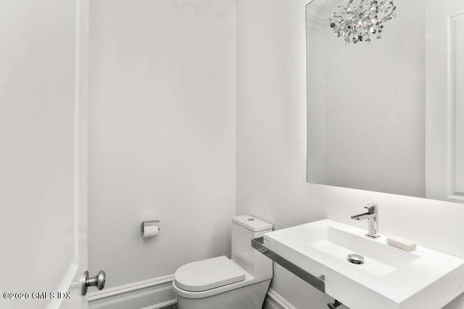 60 Club Road Riverside, CT 06878 - Photo 20 of 44 a bathroom with a sink a toilet and mirror