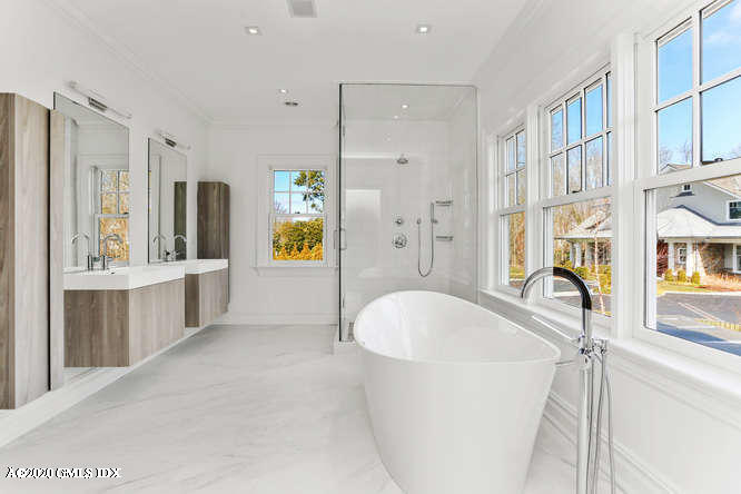 60 Club Road Riverside, CT 06878 - Photo 24 of 44 a spacious bathroom with a tub sink and mirror