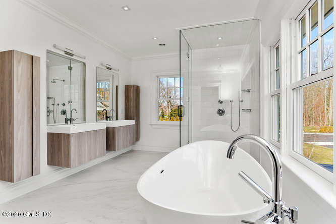 60 Club Road Riverside, CT 06878 - Photo 25 of 44 a bathroom with a bathtub shower sink and mirror