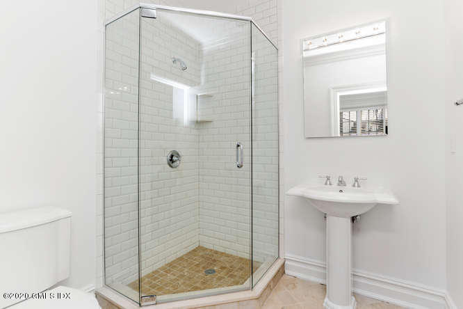 60 Club Road Riverside, CT 06878 - Photo 32 of 44 a bathroom with a sink a mirror and shower