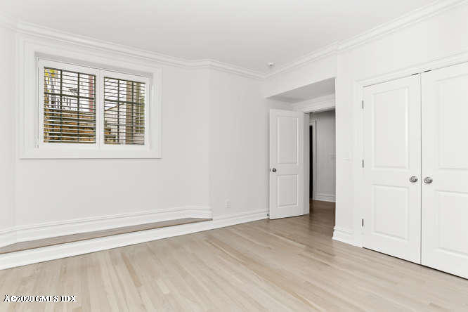 60 Club Road Riverside, CT 06878 - Photo 33 of 44 a view of an empty room with wooden floor and a window