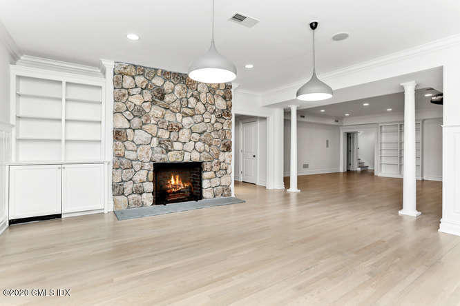 60 Club Road Riverside, CT 06878 - Photo 36 of 44 a view of a room with a fireplace and wooden floor