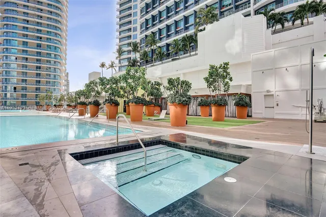 a kitchen with kitchen island a sink appliances cabinets and a counter top space