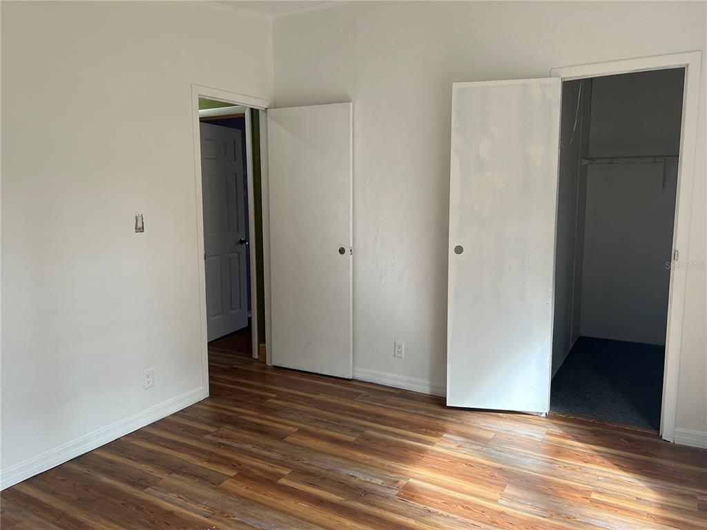 9867 Jerome Drive New Port Richey, FL 34654 - Photo 20 of 30 a view of an empty room with wooden floor and closet