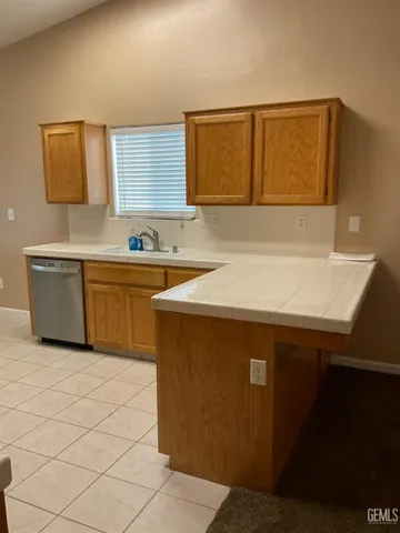 a kitchen with stainless steel appliances a sink and a cabinets