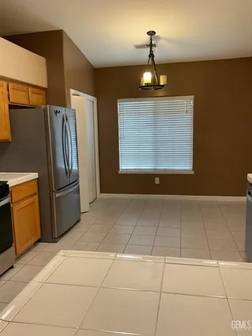 a view of an empty room with a kitchen