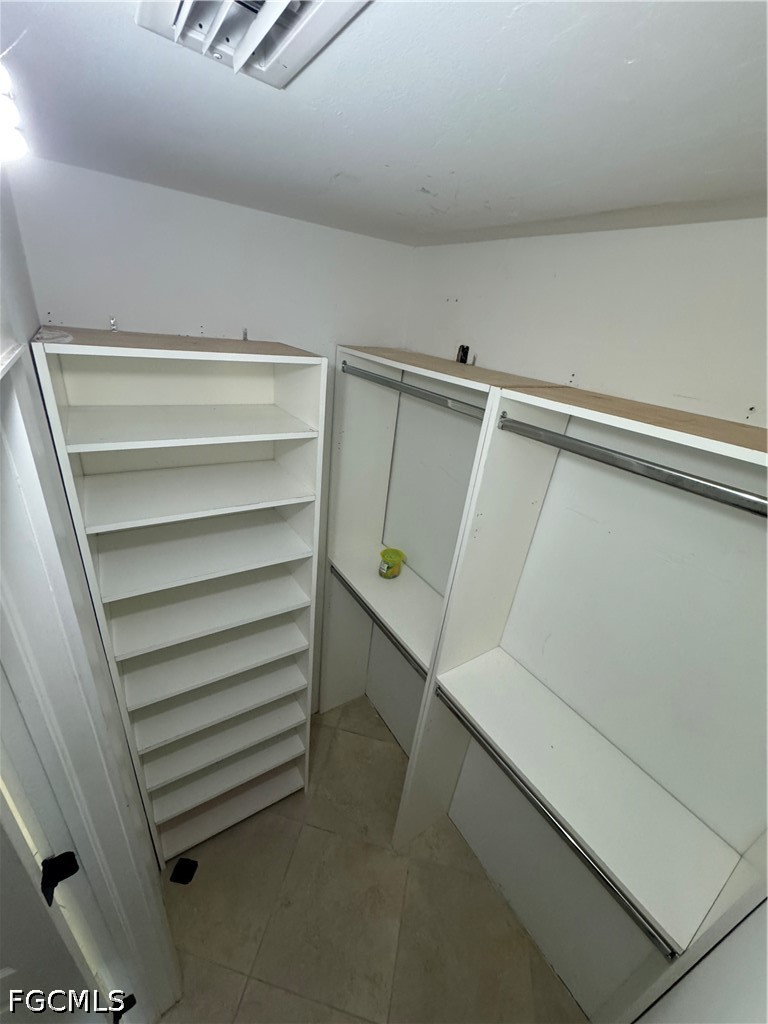 3313 35th Street West Lehigh Acres, FL 33971 - Photo 11 of 15 a view of walk in closet with empty racks