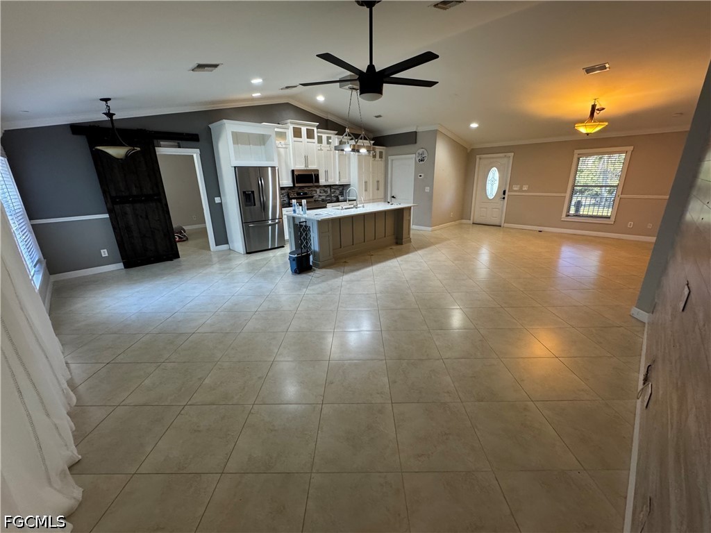 3313 35th Street West Lehigh Acres, FL 33971 - Photo 4 of 15 a view of a kitchen with a sink and a refrigerator