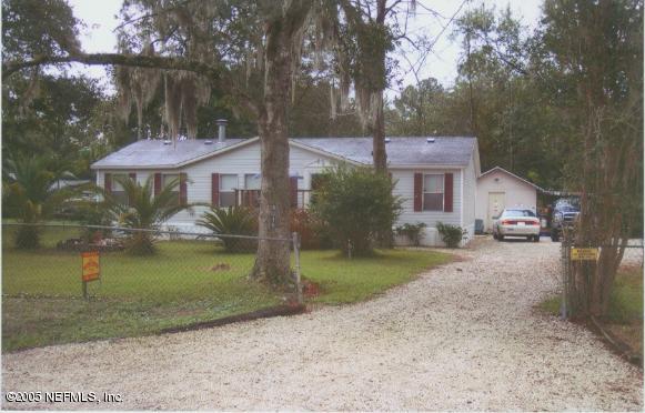 8316 Metto Road Jacksonville, FL 32244 - Photo 3 of 3 a view of a house with a yard and a large tree