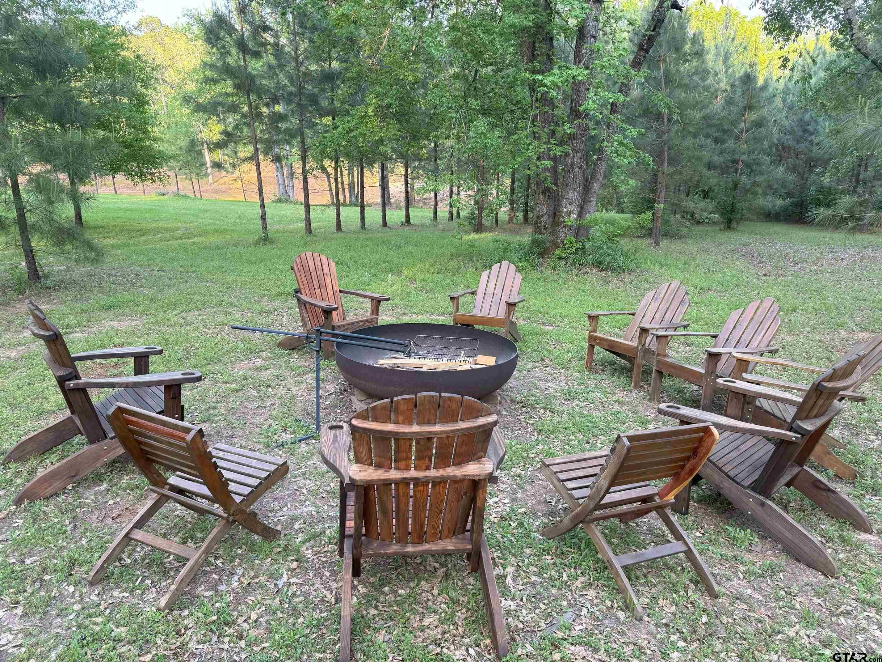 782 Rosie Wady Road Gladewater, TX 75647 - Photo 44 of 48 a backyard of a house with table and chairs