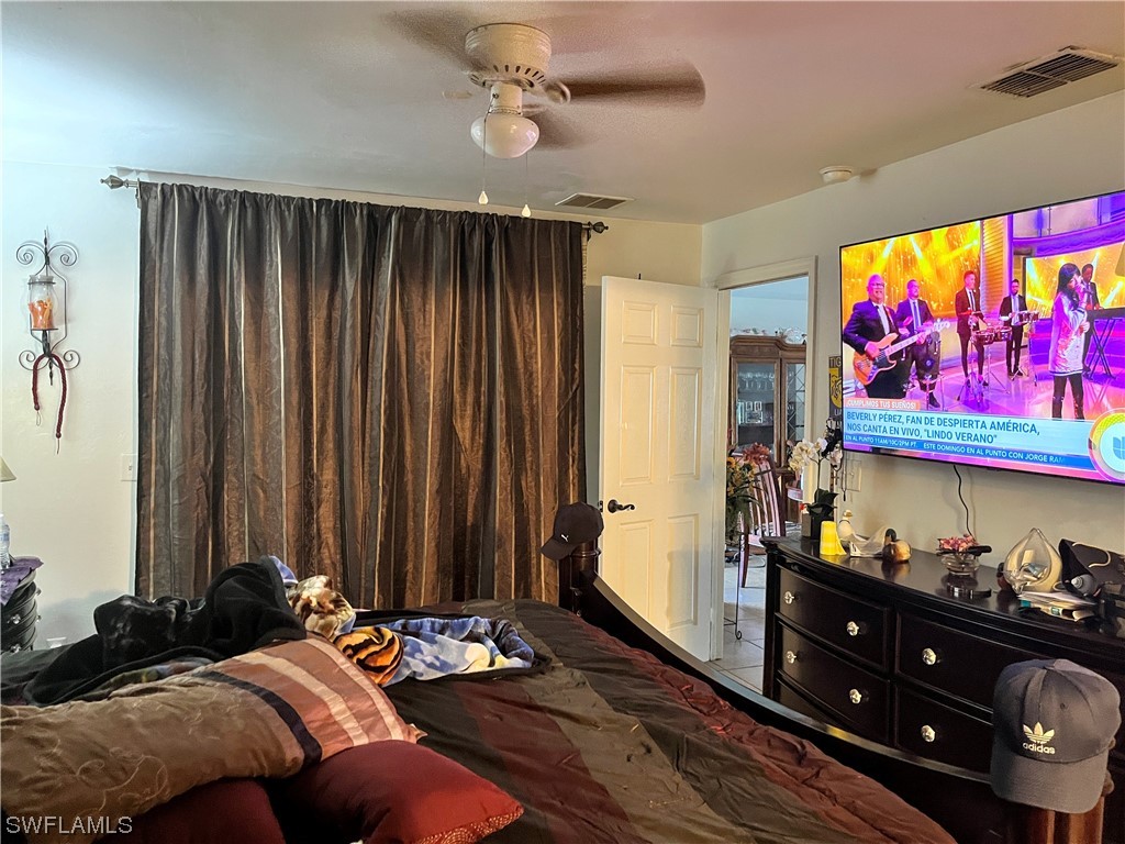 8240-8242 Matanzas Road Fort Myers, FL 33967 - Photo 5 of 8 a bed room with a bed and a television