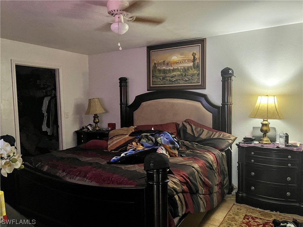 8240-8242 Matanzas Road Fort Myers, FL 33967 - Photo 6 of 8 a bedroom with a bed and a chandelier