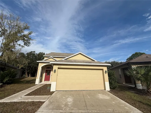 a front view of a house with a yard and garage
