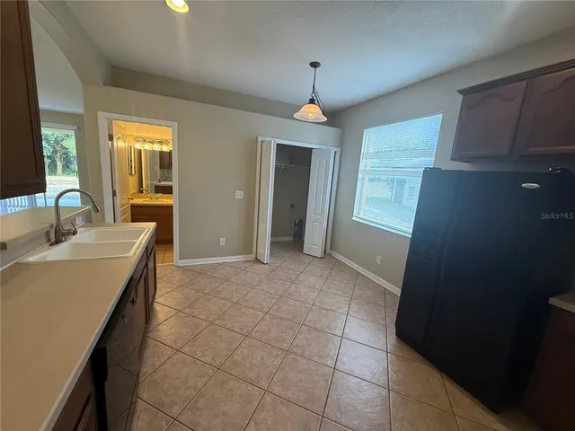 a spacious bathroom with a granite countertop sink a mirror and a shower
