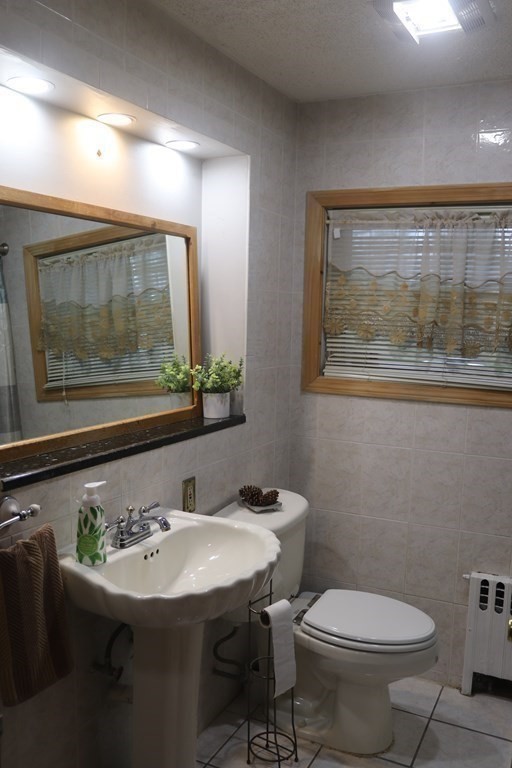 35 Park Road Springfield, MA 01107 - Photo 8 of 23 a bathroom with a sink mirror and toilet