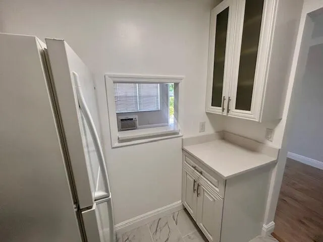 a kitchen with a refrigerator a sink and a window