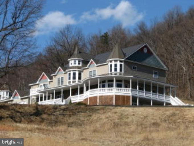 a house with tall trees in the background