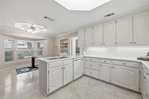 a kitchen with a sink and cabinets