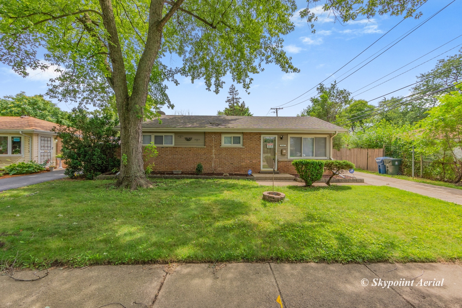 a front view of a house with yard patio and green space