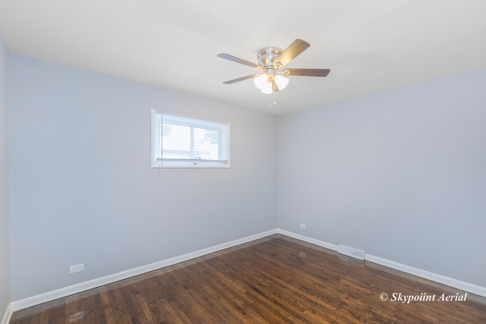 3145 Nottingham Avenue Markham, IL 60428 - Photo 11 of 27 a view of an empty room with wooden floor and a window