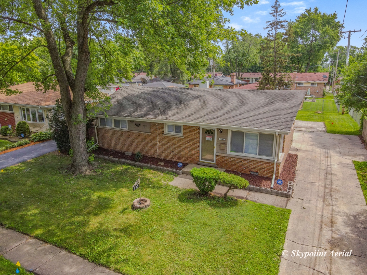 3145 Nottingham Avenue Markham, IL 60428 - Photo 24 of 27 a aerial view of a house with table and chairs under an umbrella