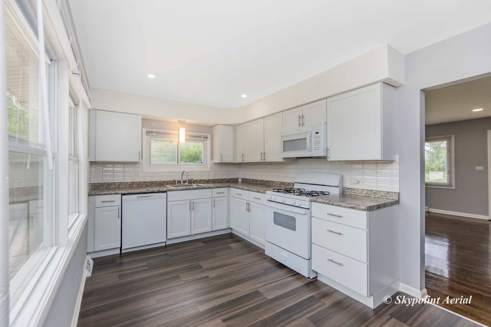 3145 Nottingham Avenue Markham, IL 60428 - Photo 7 of 27 a kitchen with granite countertop white cabinets and wooden floor