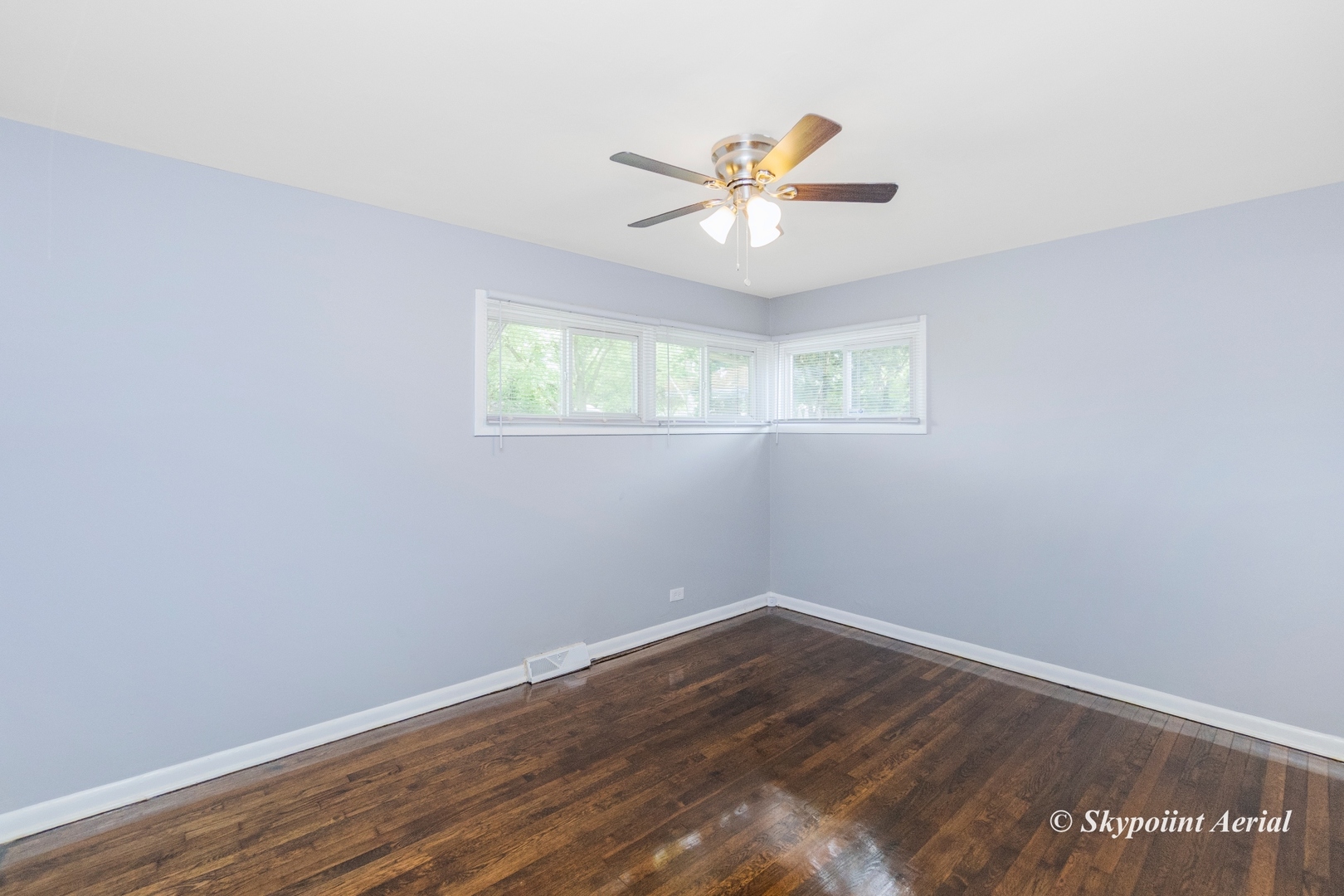 3145 Nottingham Avenue Markham, IL 60428 - Photo 9 of 27 a view of an empty room with wooden floor and a window