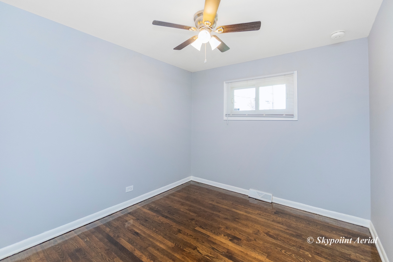 3145 Nottingham Avenue Markham, IL 60428 - Photo 10 of 27 wooden floor in an empty room with a window