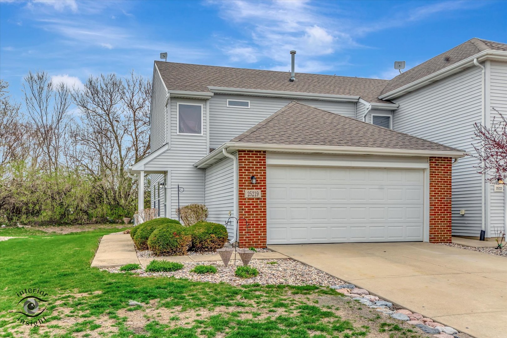 25219 Faraday Road Manhattan, IL 60442 - Photo 1 of 18 a front view of a house with a yard and garage