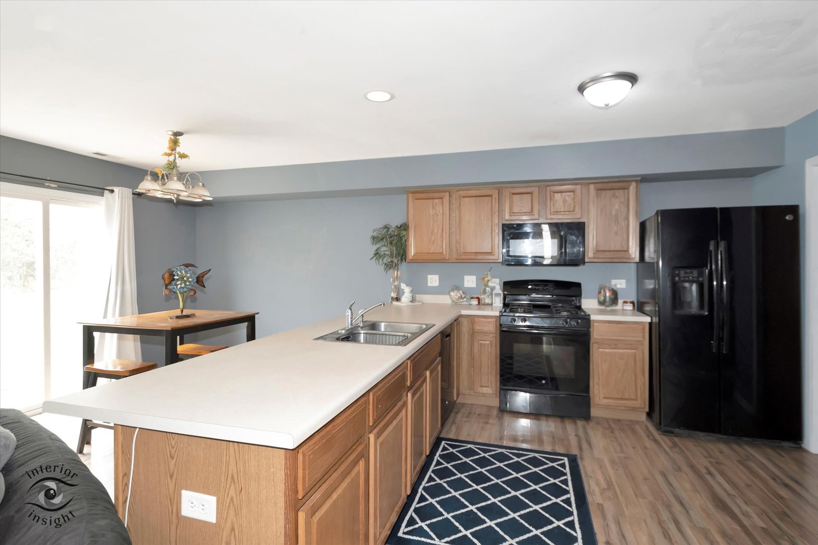 25219 Faraday Road Manhattan, IL 60442 - Photo 10 of 18 a kitchen with a stove a sink and a refrigerator