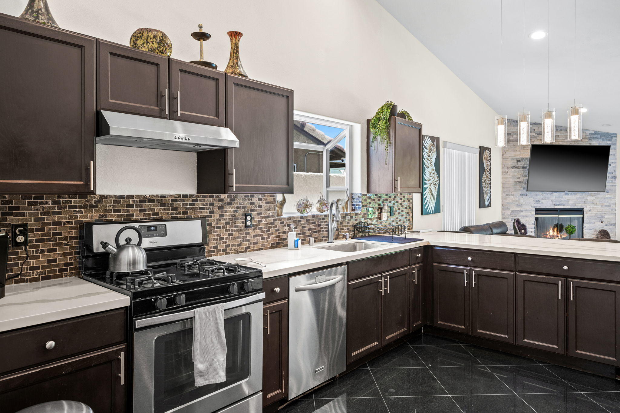 68210 Empalmo Road Cathedral City, CA 92234 - Photo 12 of 34 a kitchen with stainless steel appliances a sink stove and cabinets