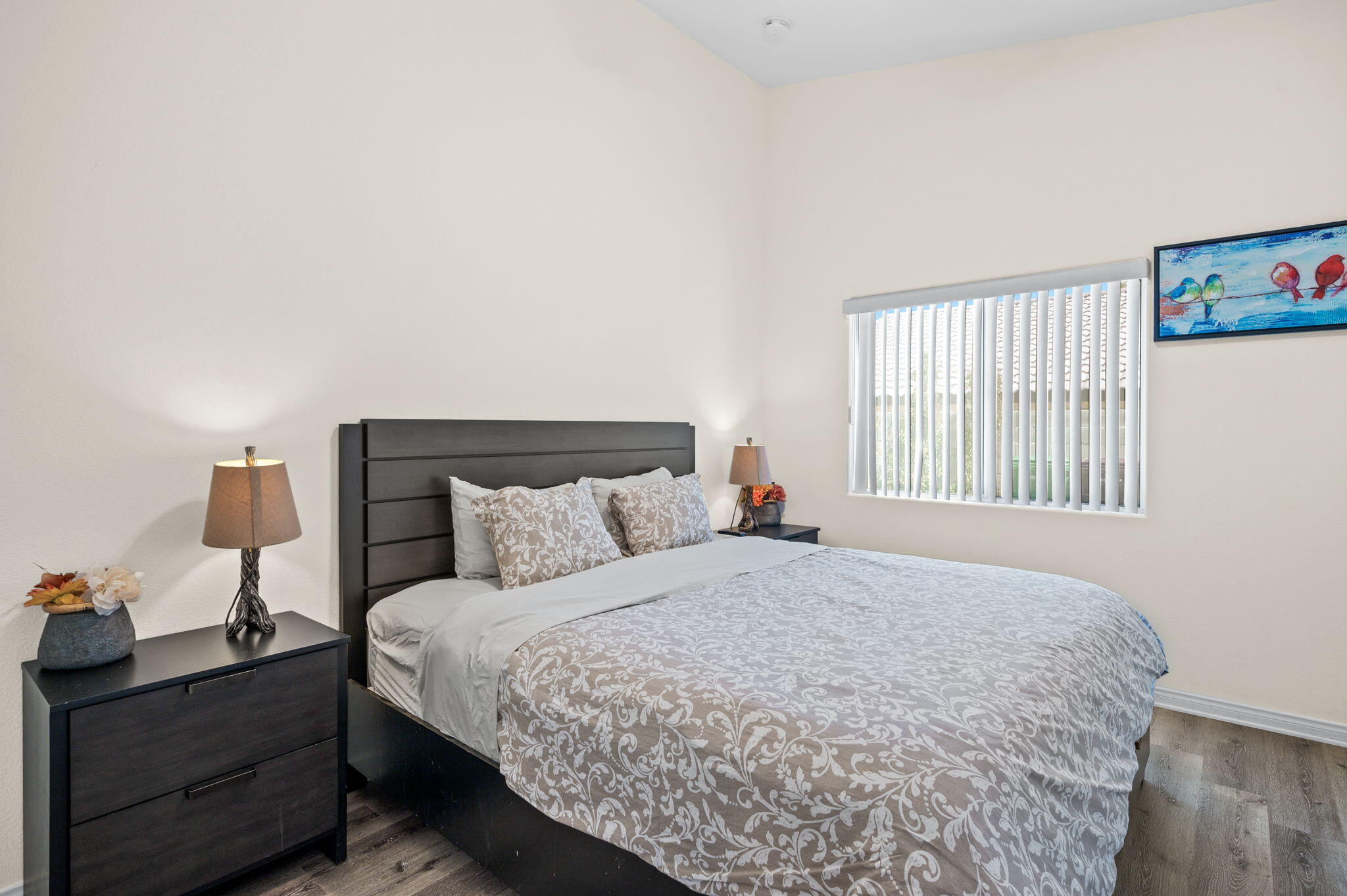 68210 Empalmo Road Cathedral City, CA 92234 - Photo 18 of 34 a bedroom with a bed and a lamp on dresser
