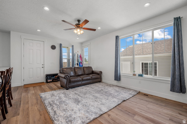 1693 North Center Point Lane Salem, UT 84653 - Photo 9 of 26 Spacious living area featuring wood-finish flooring, recessed lighting, and a ceiling fan with integrated lighting