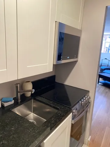 a kitchen with a sink and a stove top oven