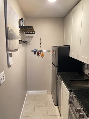 a kitchen with a refrigerator and a stove