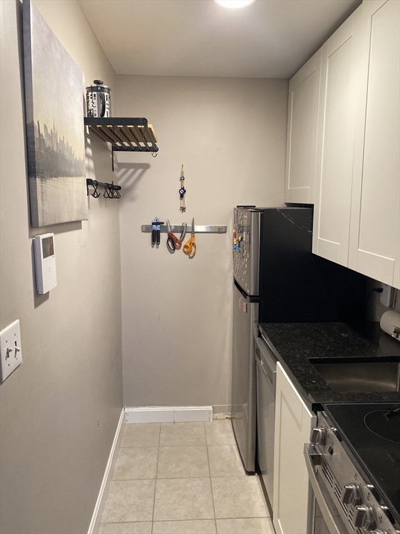 34 Hancock Street, Unit 1D Boston, MA 02114 - Photo 8 of 10 a kitchen with a refrigerator and a stove