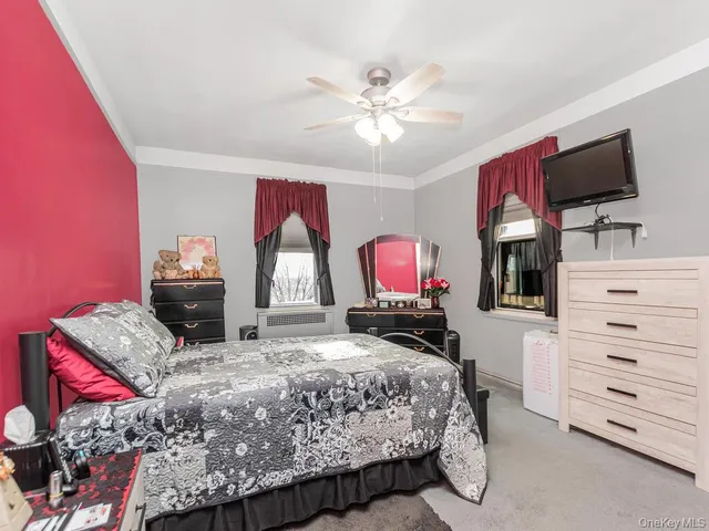 a bedroom with a bed and flat screen tv