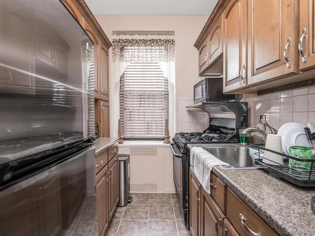 a kitchen with stainless steel appliances granite countertop a stove and a microwave