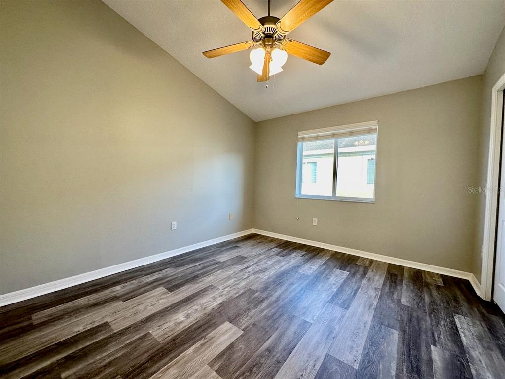 8532 Brushleaf Way Tampa, FL 33647 - Photo 14 of 20 a view of an empty room with wooden floor and a window