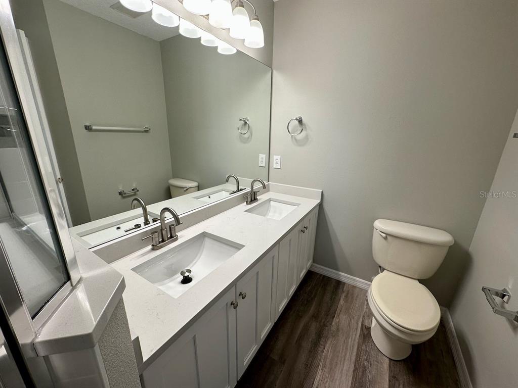 8532 Brushleaf Way Tampa, FL 33647 - Photo 16 of 20 a bathroom with a toilet sink and mirror