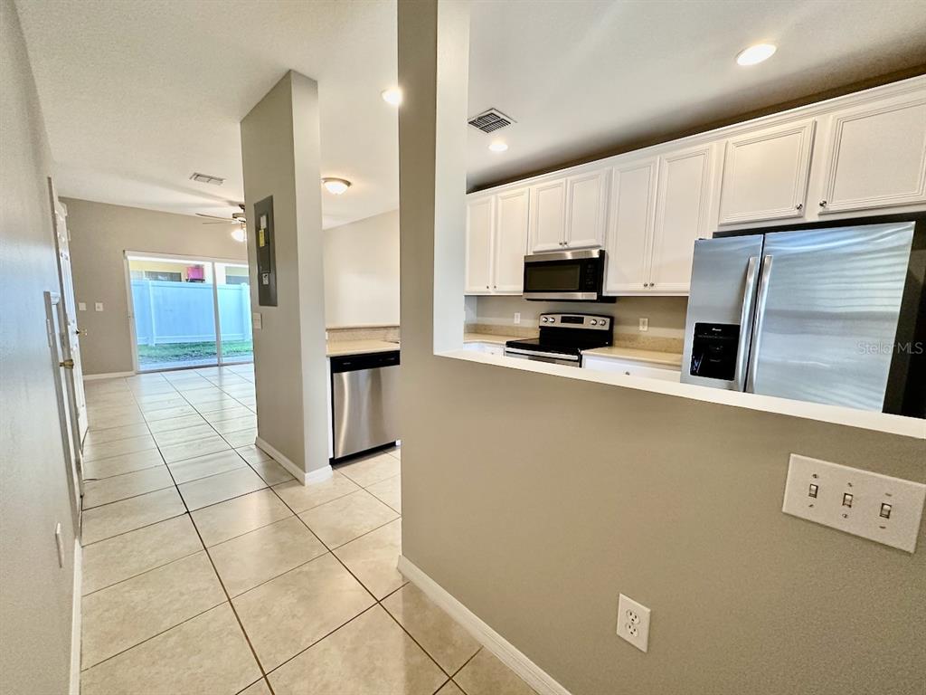 8532 Brushleaf Way Tampa, FL 33647 - Photo 2 of 20 a kitchen with stainless steel appliances a refrigerator a stove a microwave and a sink