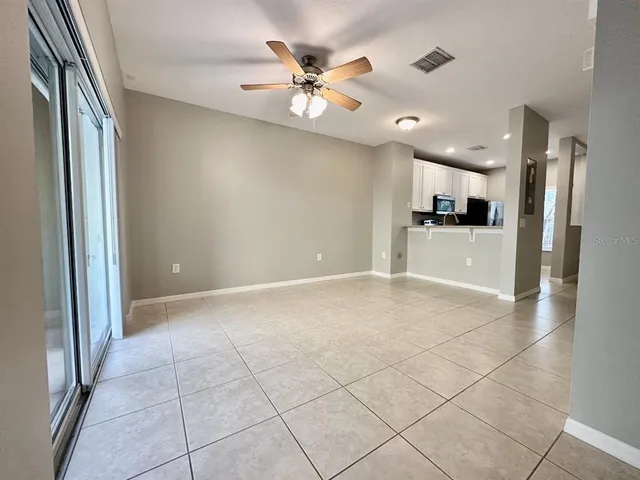 a view of a livingroom with a ceiling fan and window