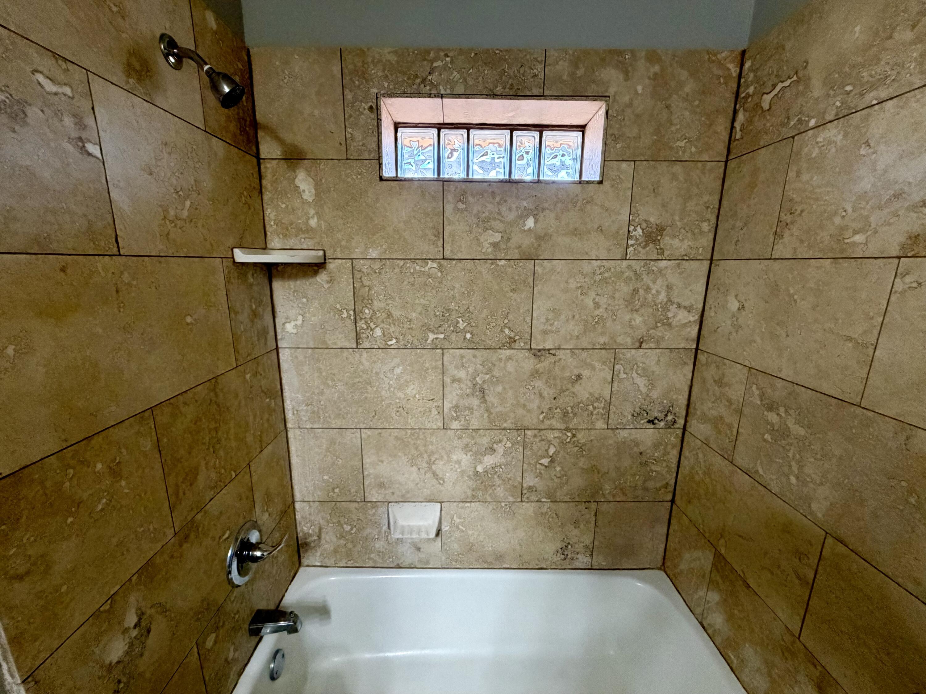 3813 51st Street, Unit A Lubbock, TX 79413 - Photo 10 of 17 a bathroom with a bathtub