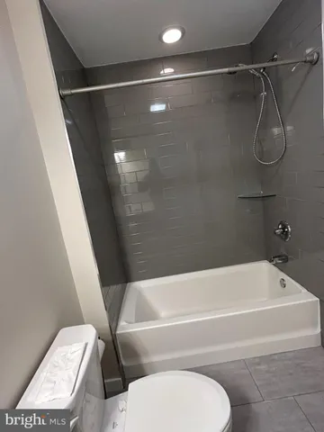 a bathroom with a toilet and a bathtub