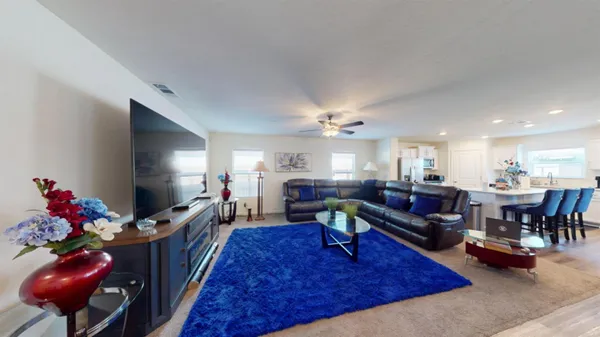 a kitchen with stainless steel appliances granite countertop a refrigerator a stove and white cabinets