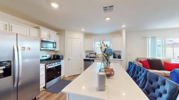 a large kitchen with sink a stove and cabinets