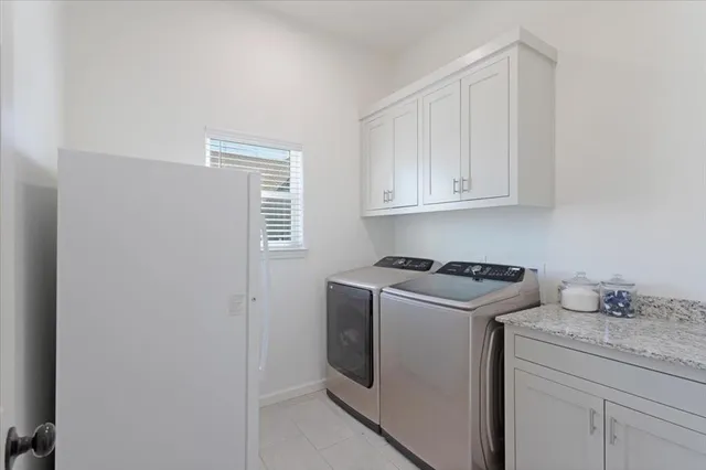 a kitchen with granite countertop cabinets washer and dryer