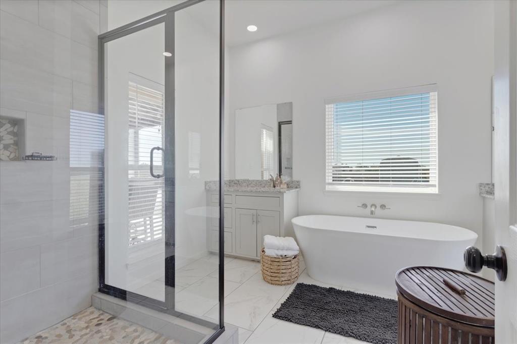 6514 Old Clarksville Road Reno, TX 75462 - Photo 21 of 27 a spacious bathroom with a bathtub a sink and a shower